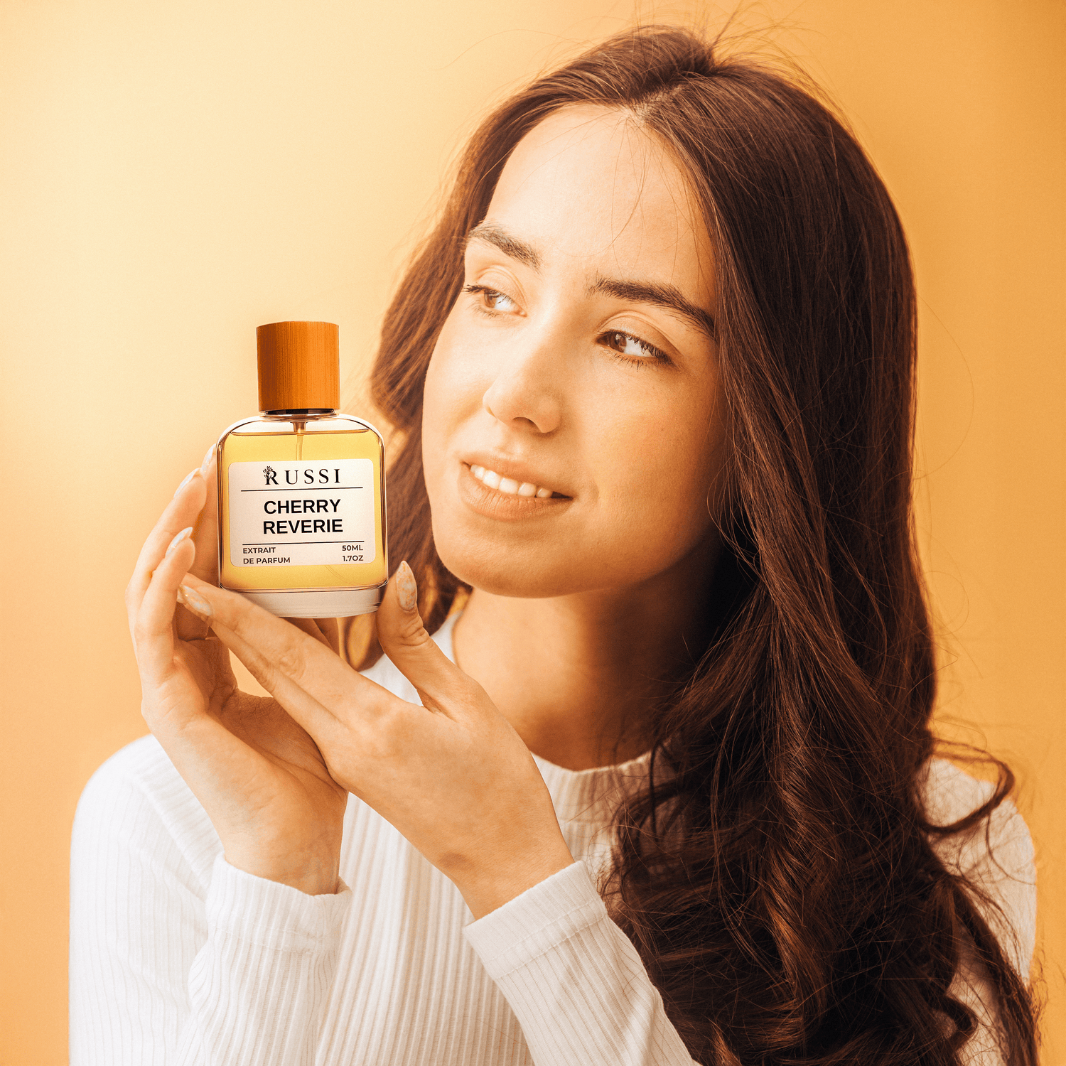 Woman holding a Russi women’s perfume bottle – elegant extrait de parfum inspired by luxury designer scents