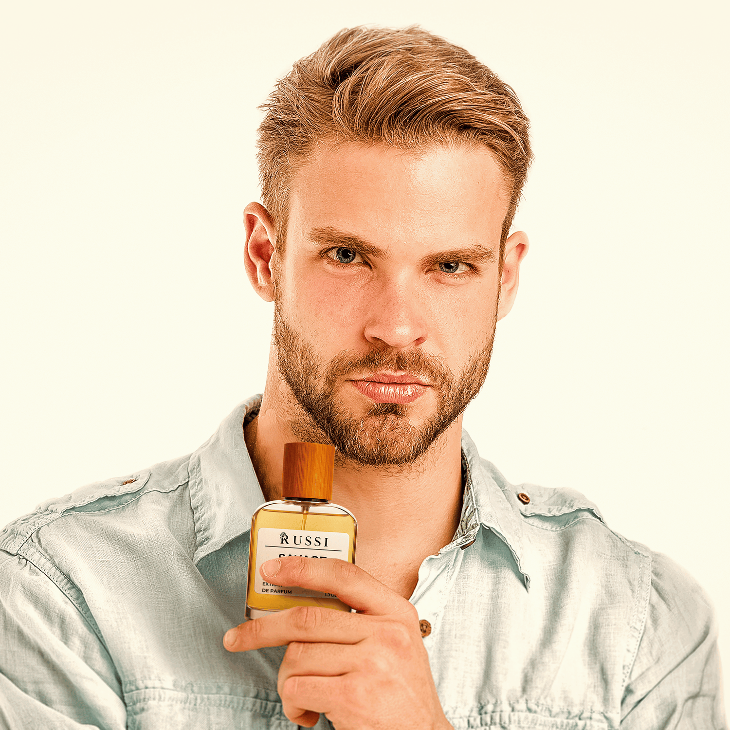Man holding a Russi men’s extrait de parfum bottle – bold and long-lasting fragrance inspired by luxury brands